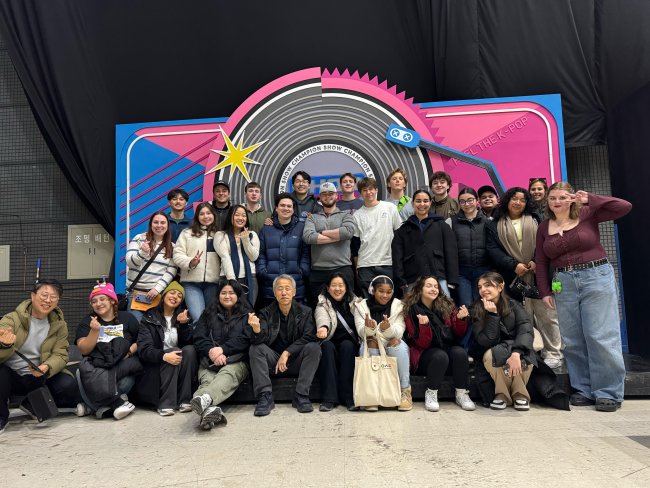 Students in front of a KPop display