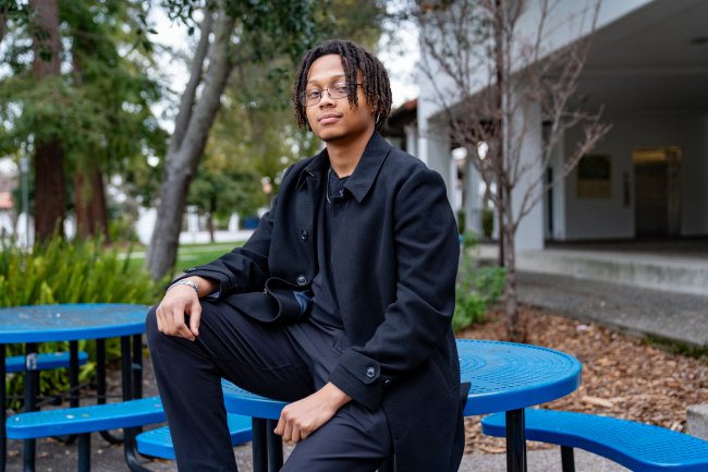 Jessiah Jones '27 sitting on table on campus