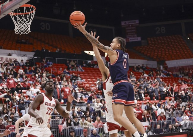 Basketball player Mikey Lewis shoots against WSU in February 2026