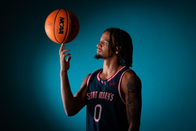 Basketball player Mikey Lewis with the ball