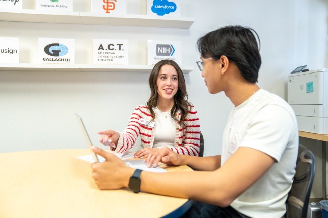 Alejandra Perez talking with a student in the Career Center