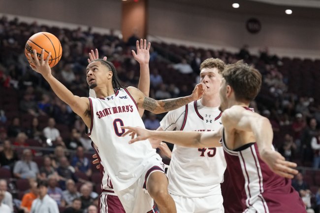 Basketball player Mikey Lewis drives against Santa Clara, with Andrew McKeever screening