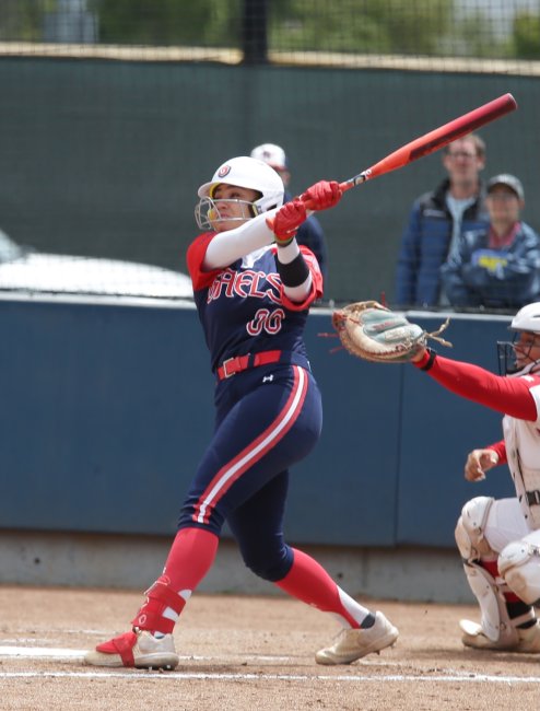 Softball player hits a ball against LMU in May 2026