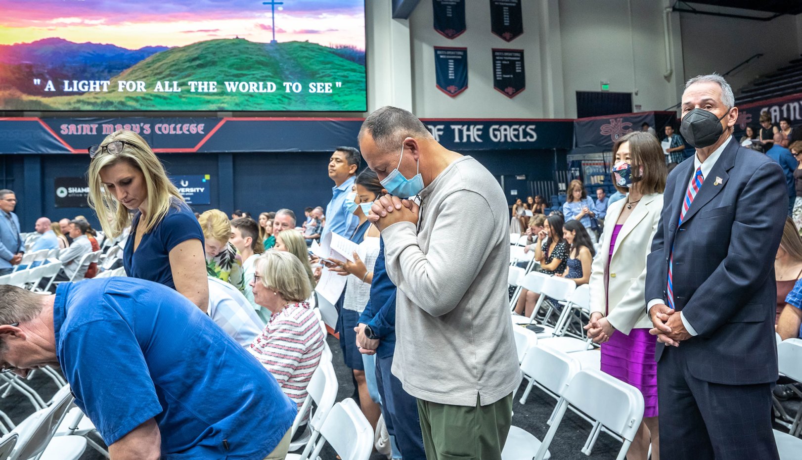 A man praying in commencement liturgy