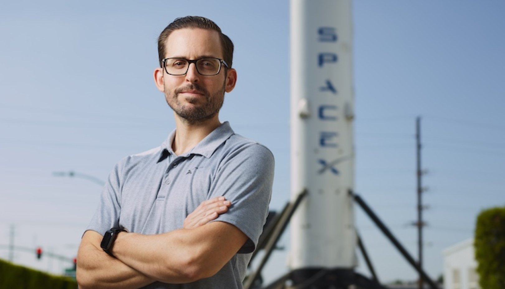 Alex Stillings in front of SpaceX rocket