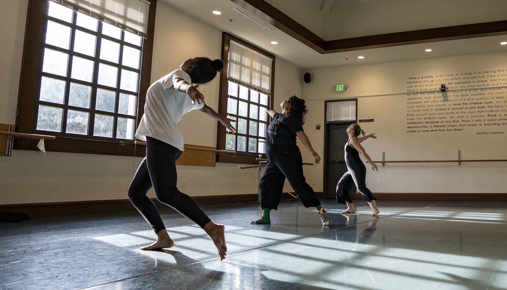 Three MFA students dancing in studio