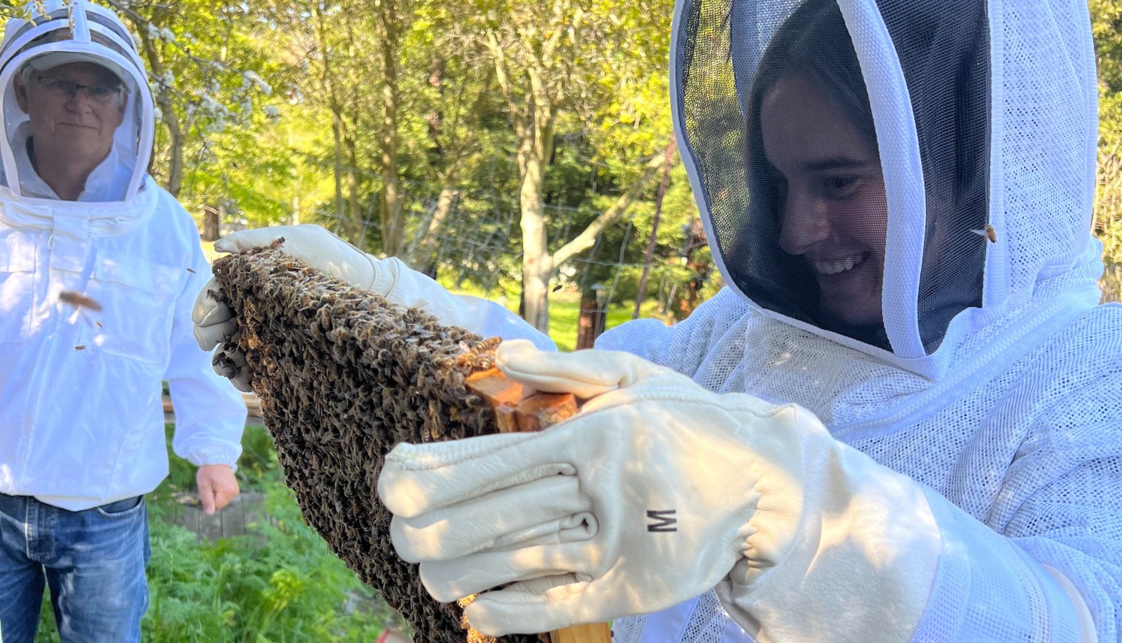 Female student Hathaway Scarping holding honeycomb