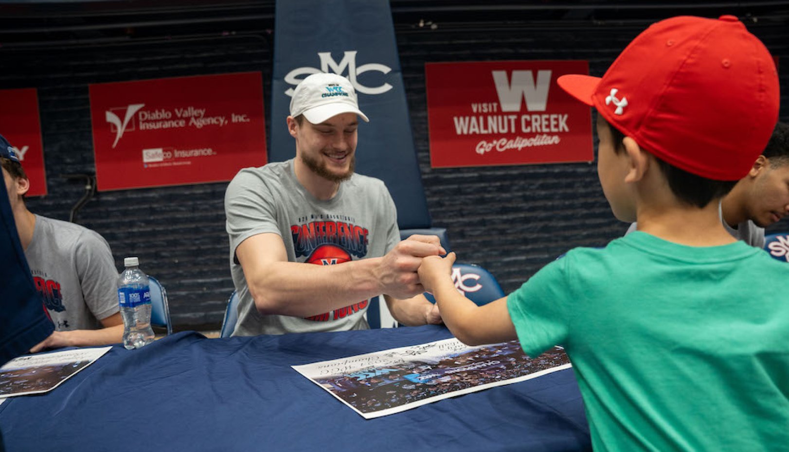 Mitchell Saxen fist bumps with young fan