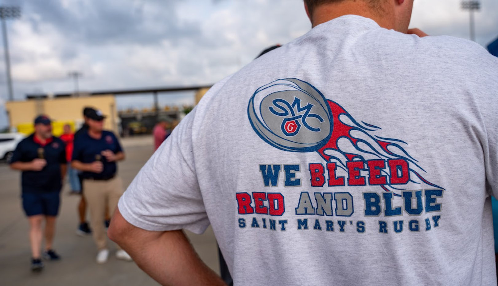 Gaels' rugby fan in T-shirt that reads We Bleed Red and Blue Saint Mary's Rugby