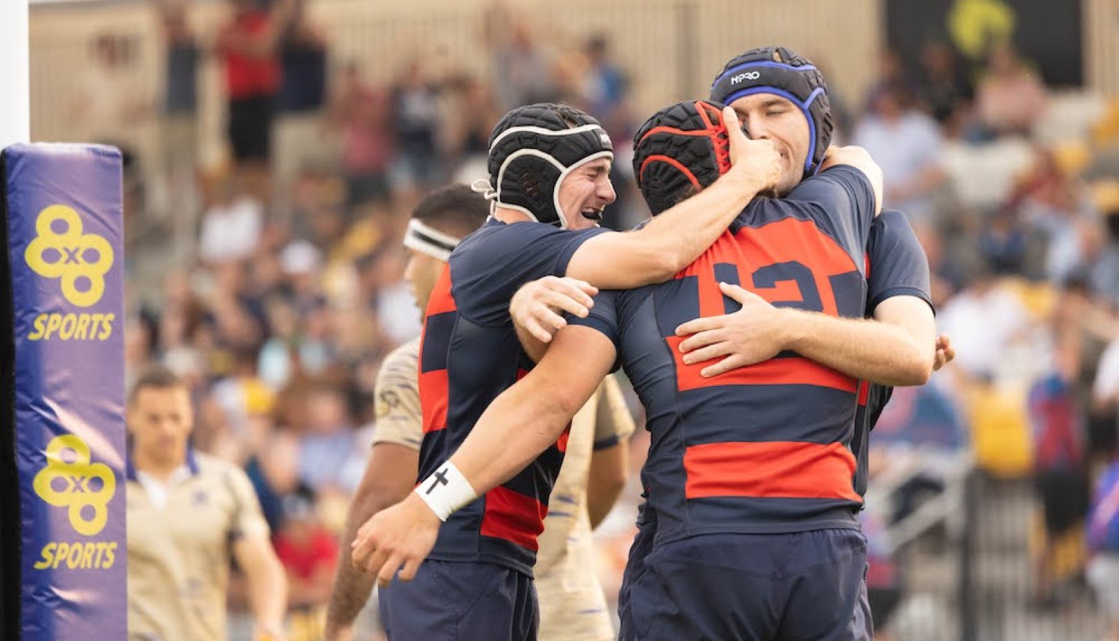 Three Saint Mary's men's rugby players celebrate scoring a try at 2024 National Championship