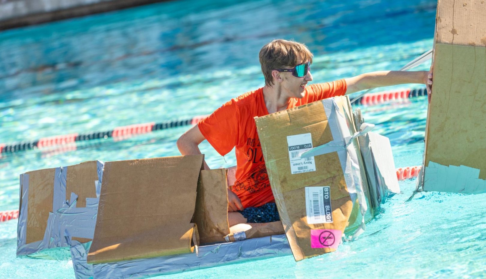 Assumption Hall cardboard canoe in water in 2024 first year olympics