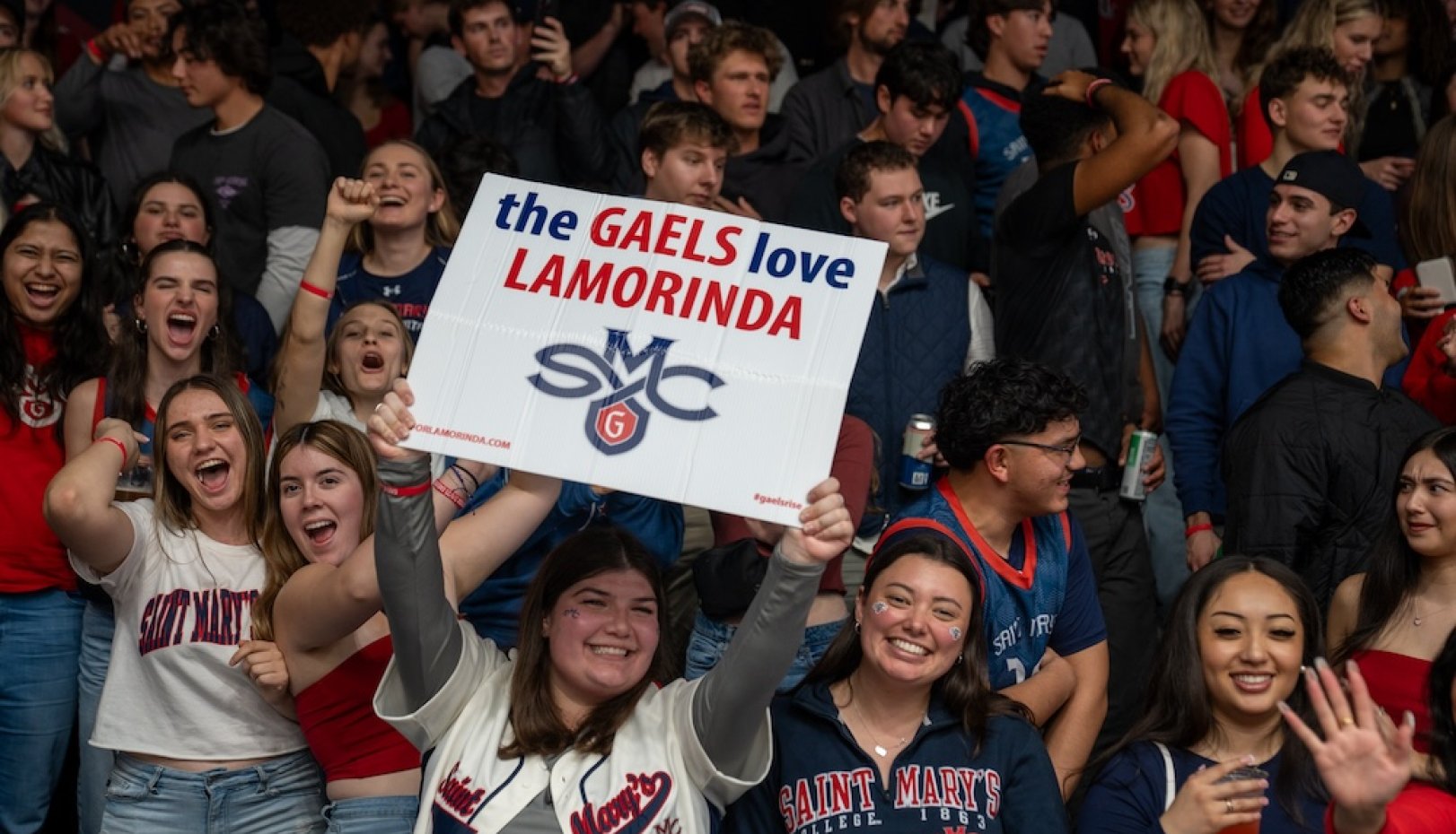 SMC fans hold a sign that says the Gaels Love LAMORINDA