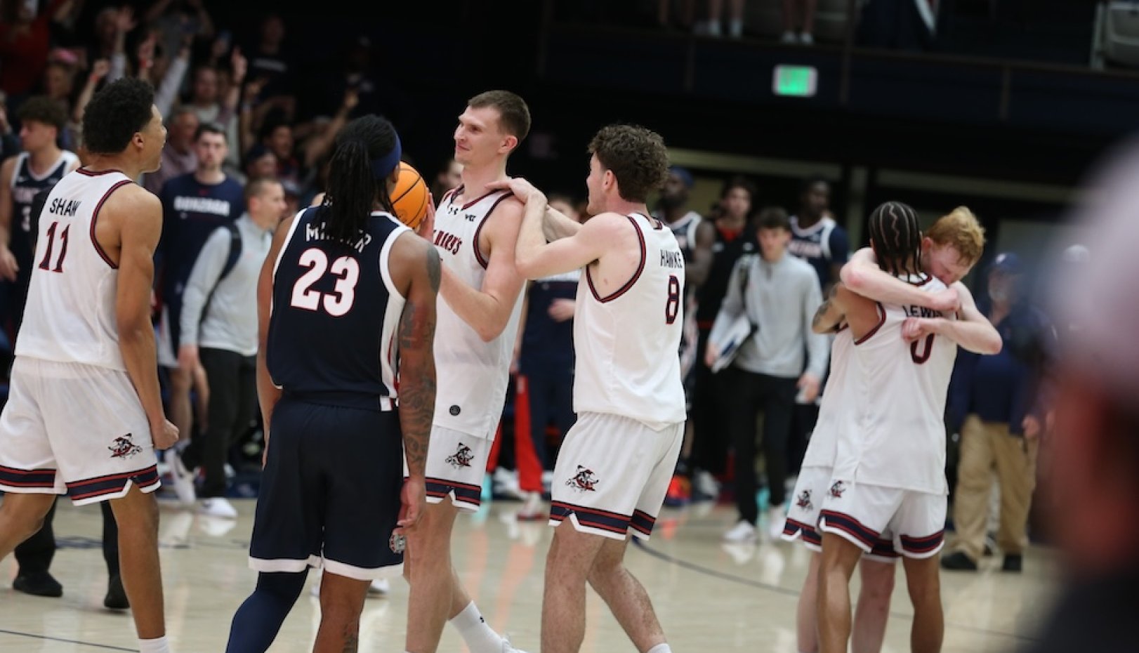 Men's Basketball players celebrate winning WCC Championship in February 2026