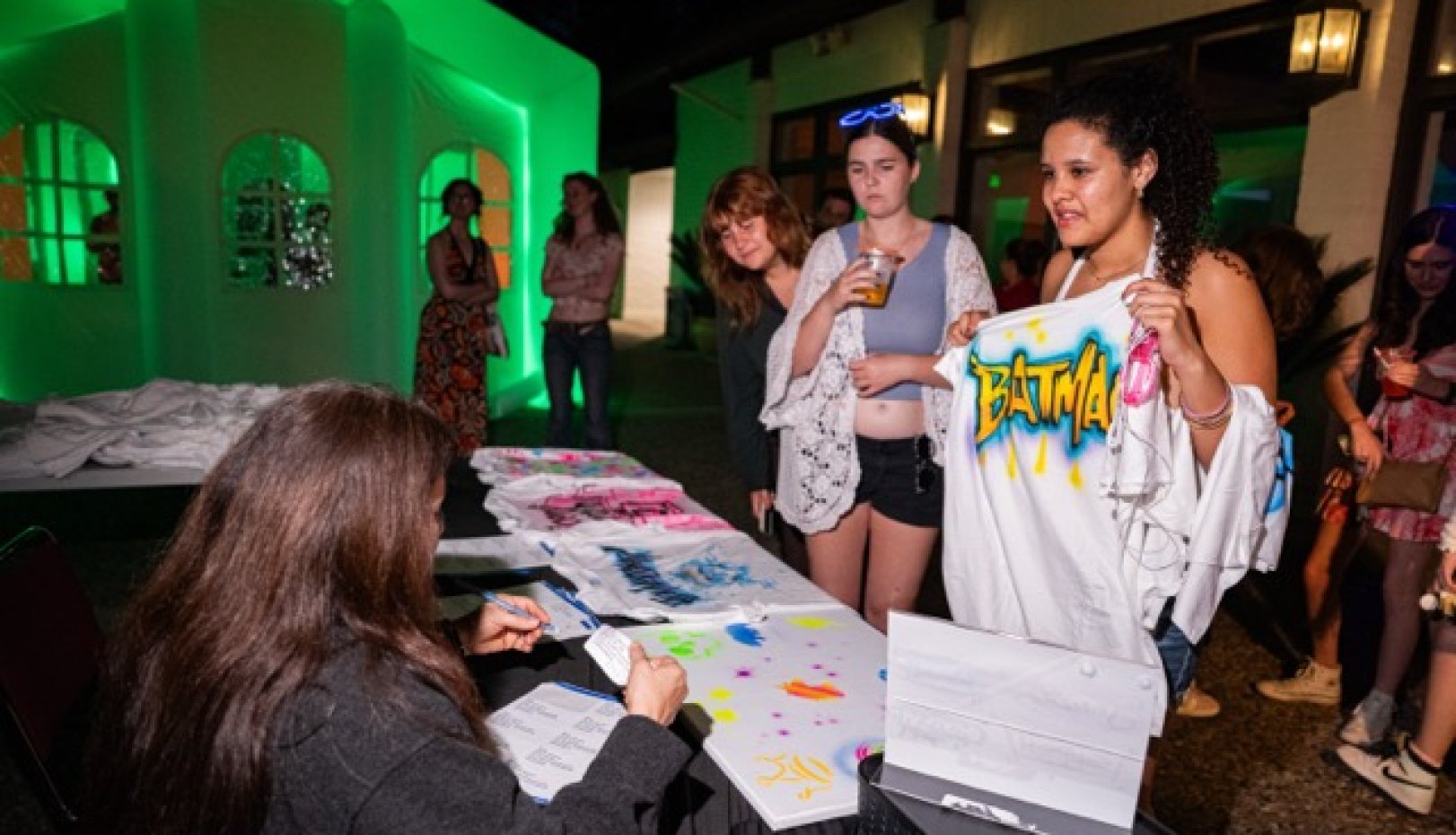 Students getting their custom airbrush shirts at Glow SMC