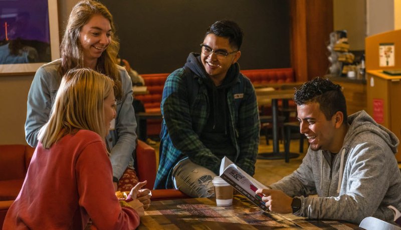students at desk having fun
