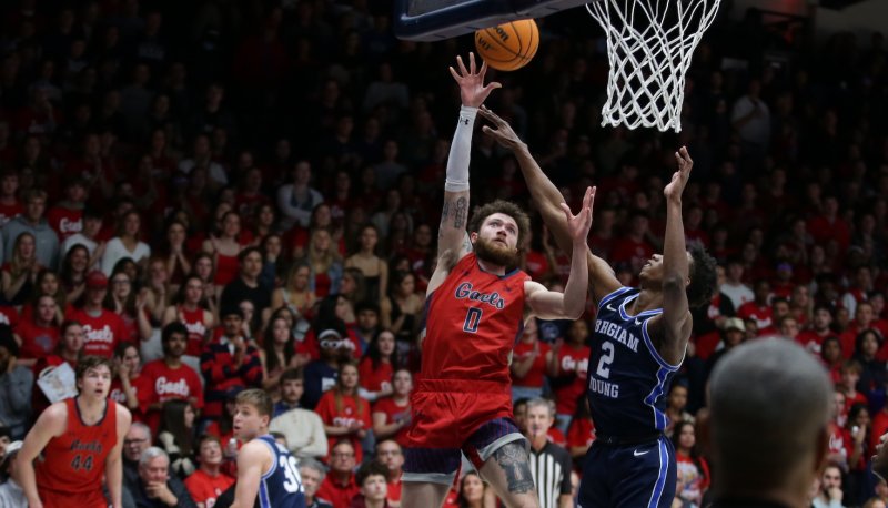 Basketball player Logan Johnson shoots against BYU on February 18