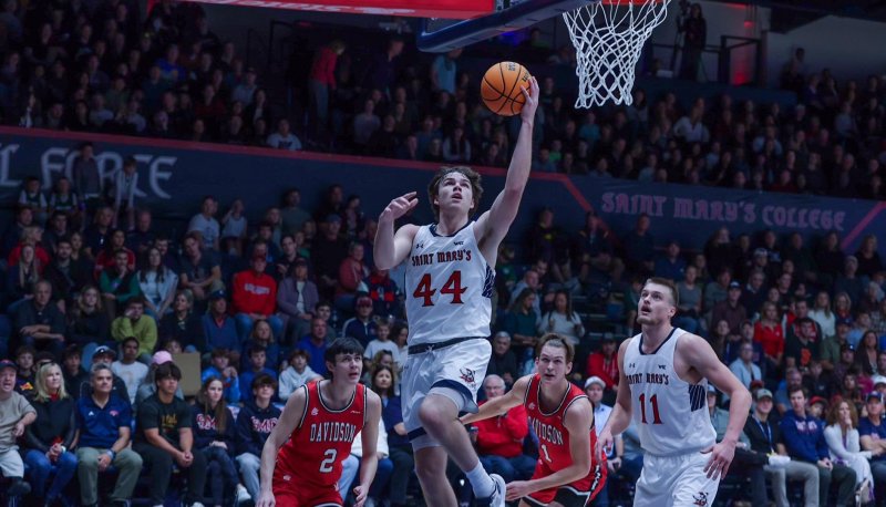 Men's basketball player Alex Ducas, No. 44, goes up for a basket against Davidson in November 2023
