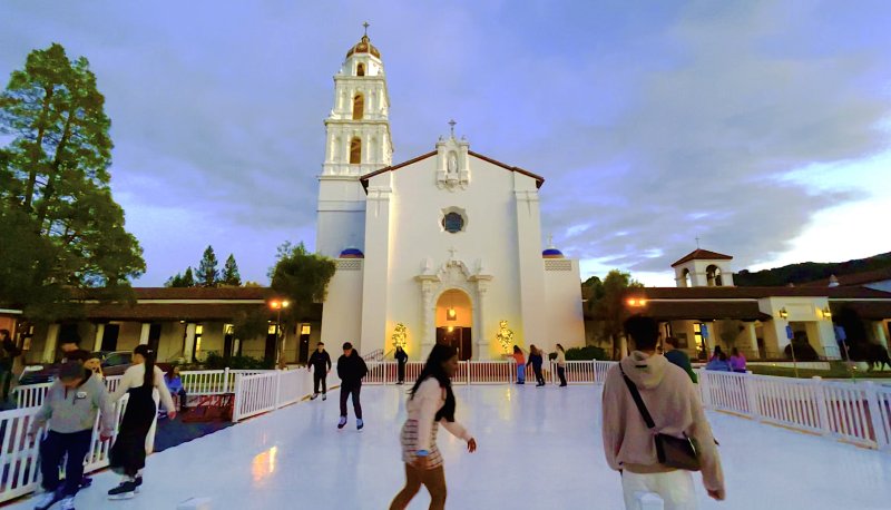 Students ice skating in front of the Saint Mary's Chapel at the 2023 Winter Fest