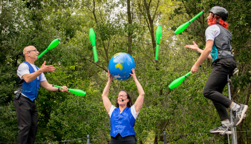 three people are juggling at the Bruns Theatre of Cal Shakes