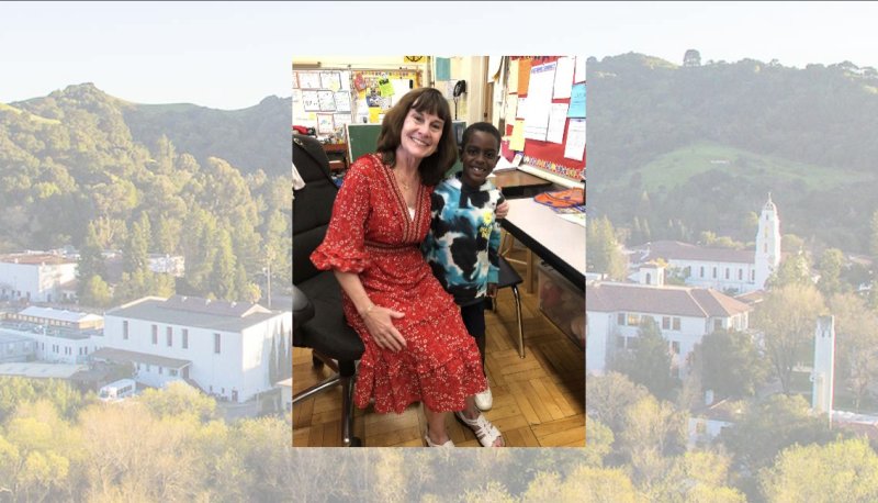 Teacher with student and screened back image of campus