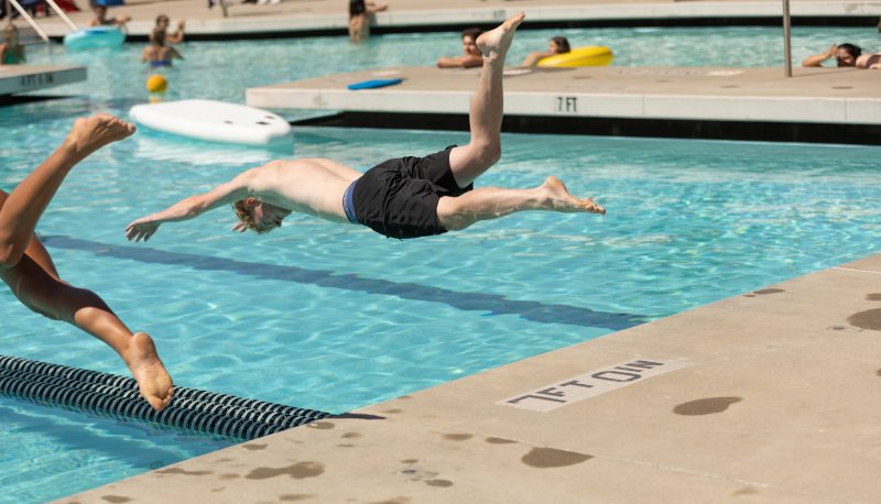 Alec Murphy ' 27 dives into the pool for the 25 yard swim race at the recreation Center
