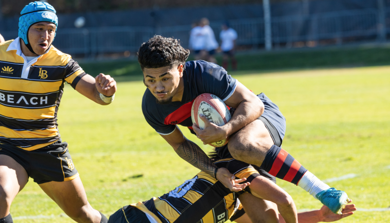 Iosefa Toia’ivao Runs through the defender during the Saint Mary's Rugby Match against Long Beach state.