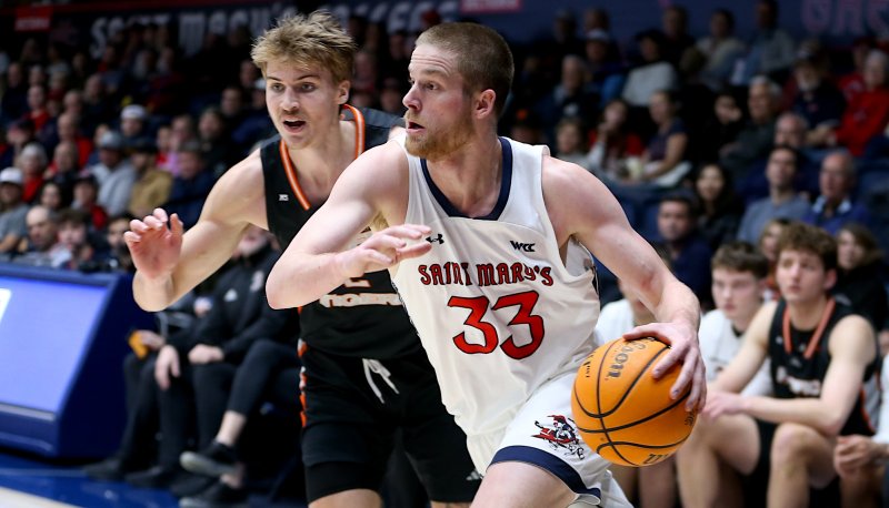 Men's Basketball player Lue Barrett drives against Pacific