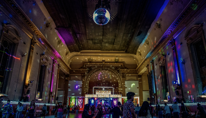 Participants roller skate at the Church of 8 Wheels with a view of the altar as the disco ball shimmers lights around the historic architecture. / Photo By Francis Tatem.