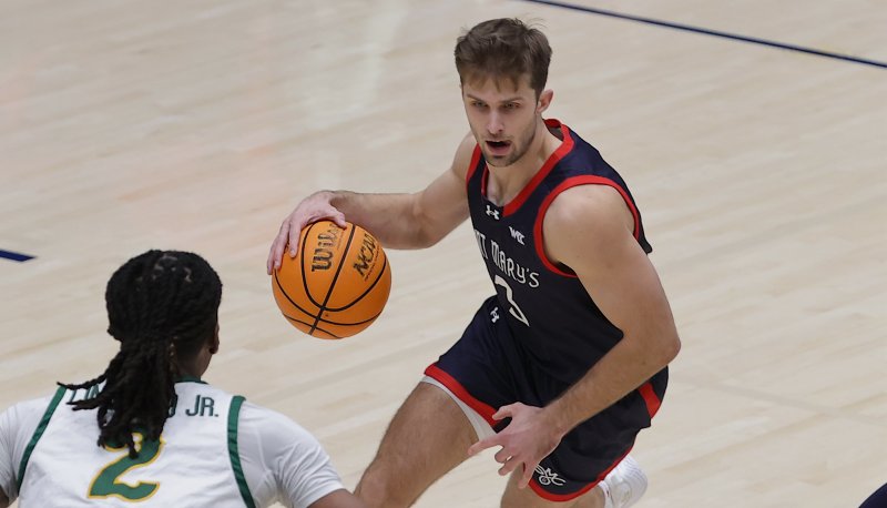 Men's basketball player Augustas Marciulionis drives against USF