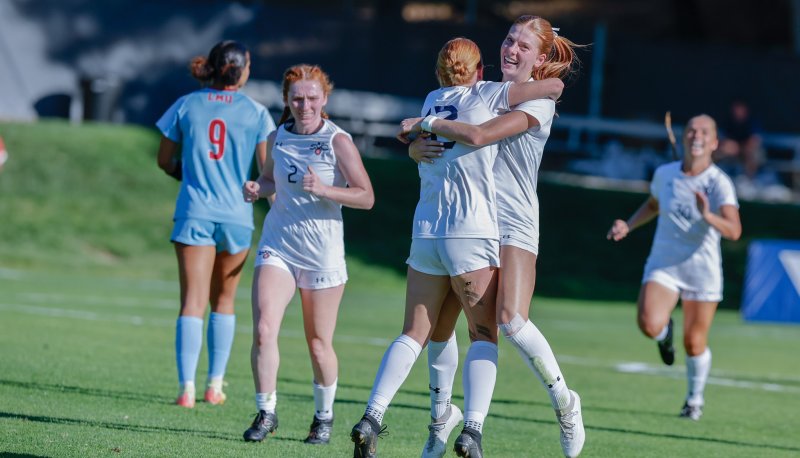 Women's soccer players celebrate in fall 2024