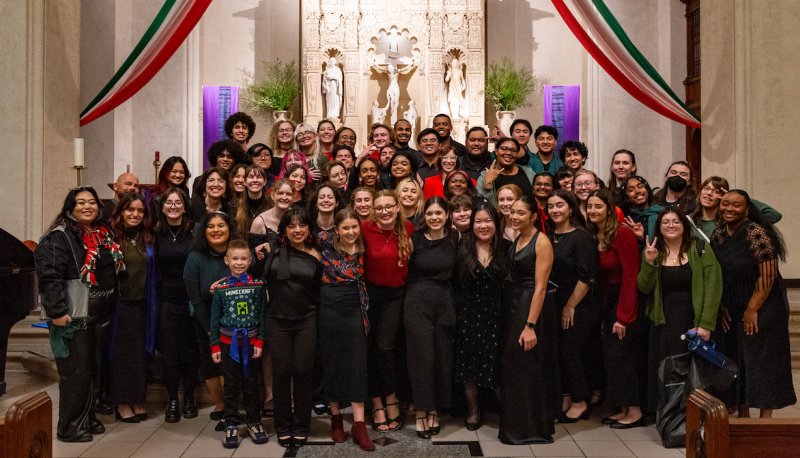 SMC &amp; DVC choir members pose on the altar after performing in their Dec '24 concert.