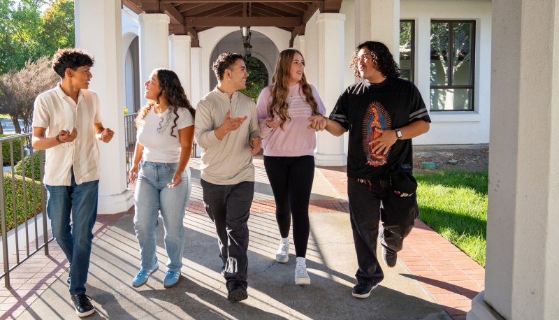 Five students walking in the arcade at Saint Mary's in fall 2025