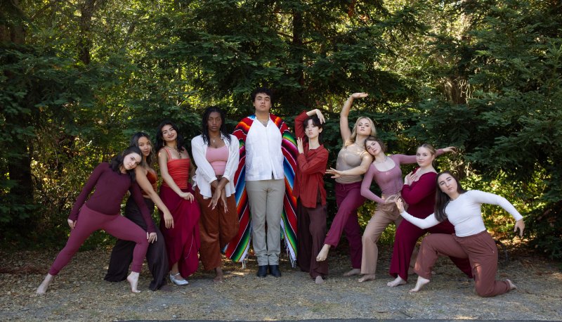 Senior SMC dancers posing in front of a forest of trees with maroon accessories and clothing.