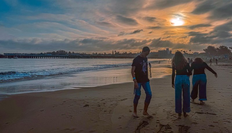 Three students on the beach at Santa Cruz in October 2025