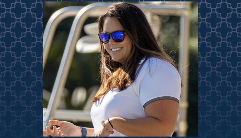 SMC Swim Coach Ellie Monobe photo against a blue patterned background