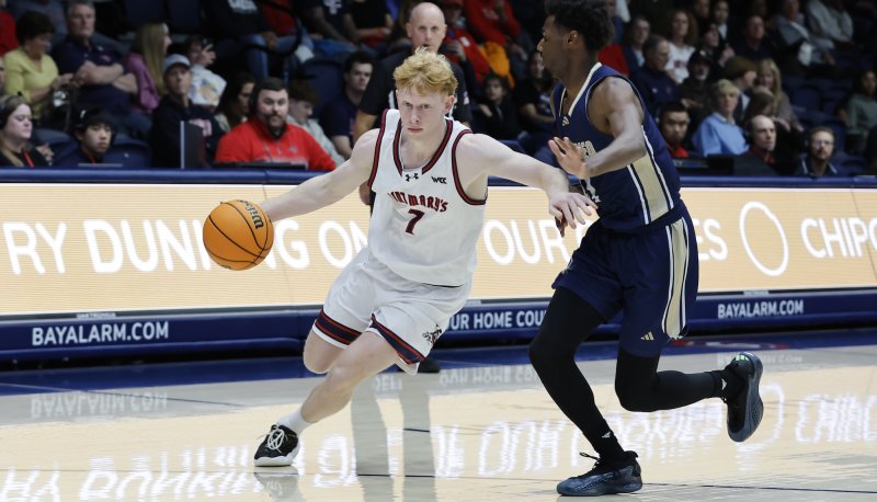 Men's basketball player Joshua Dent drives against UC Merced in November 2025