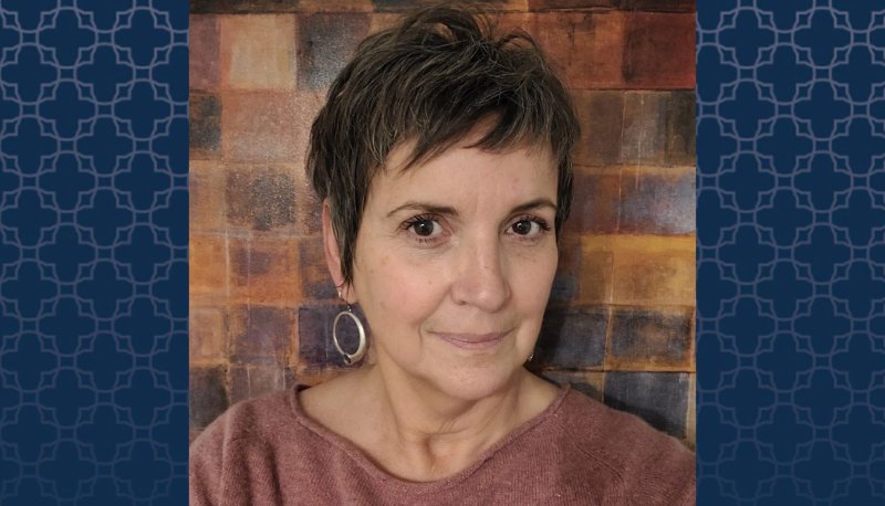 Professor Sheila Hassell Hughes with blue patterned background on sides