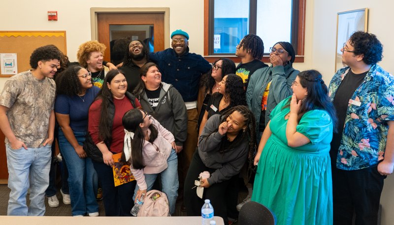 Mahershala Ali laughing with a dozen student scholars