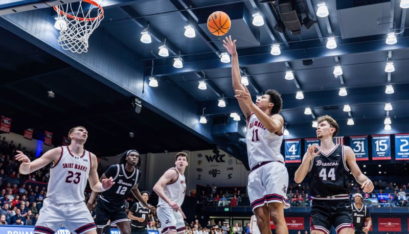 Basketball player Dillan Shaw shoots against Santa Clara in February 2026 while other players look on