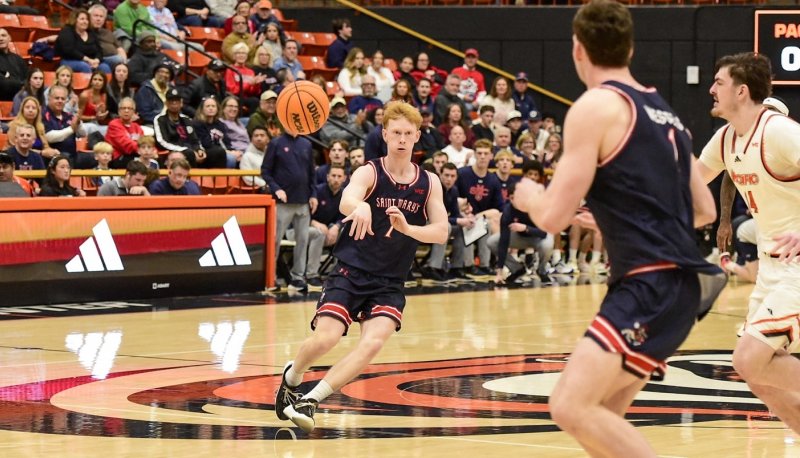 Basketball player Joshua Dent passes against Pacific in February 2026