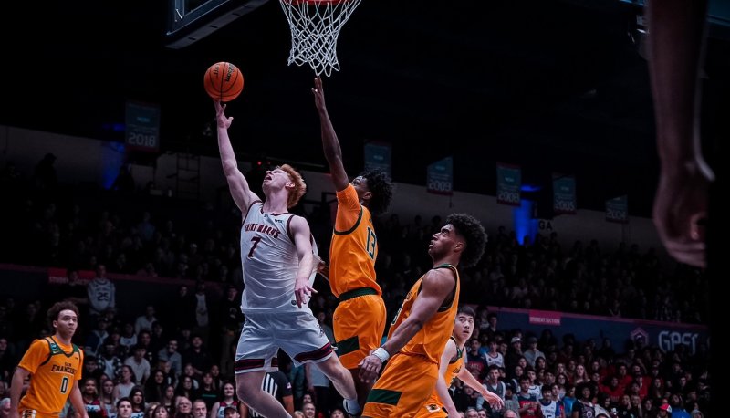 Basketball player Joshua Dent shoots against USF in February 2026