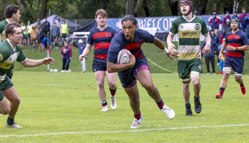 Men's Rugby student-athlete Molitika Santiago Ix-Siu runs past the Colorado State defender in an attempt to score a try.