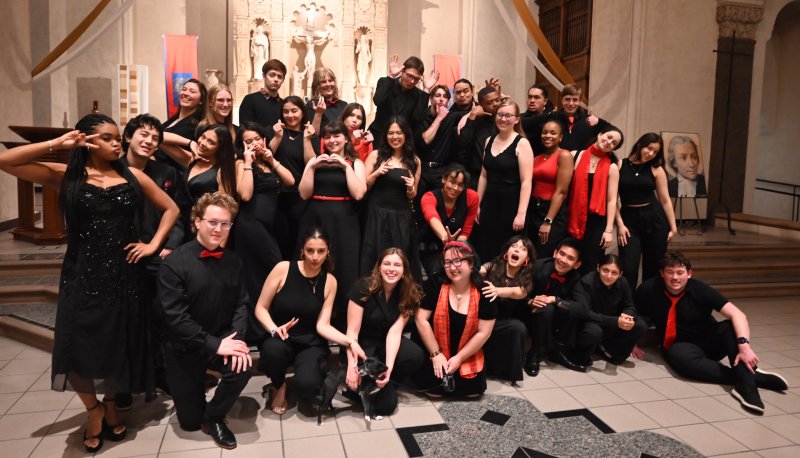 SMC Choir on the altar dressed in black and red