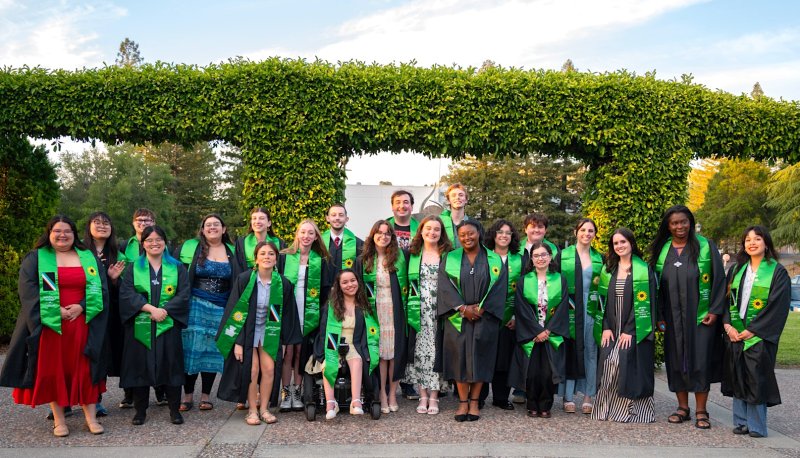 Students wearing green stoles for the Disability &amp; Neurodiversity Graduation Celebration in May 2026