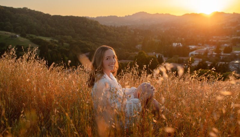 Jacquelyn Neuner on hillside overlooking Saint Mary's at sunset