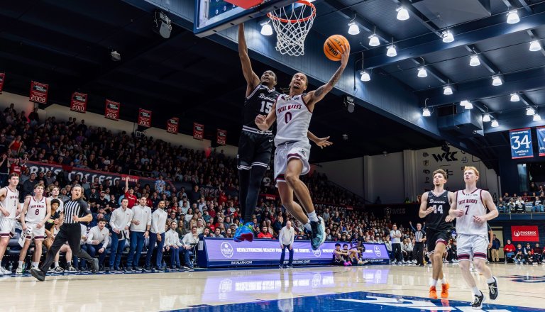 Basketball player Mikey Lewis shoots against Santa Clara in February 2026