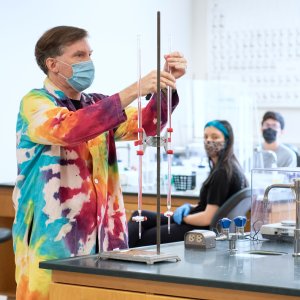 Action shot of a teacher mid science experiment