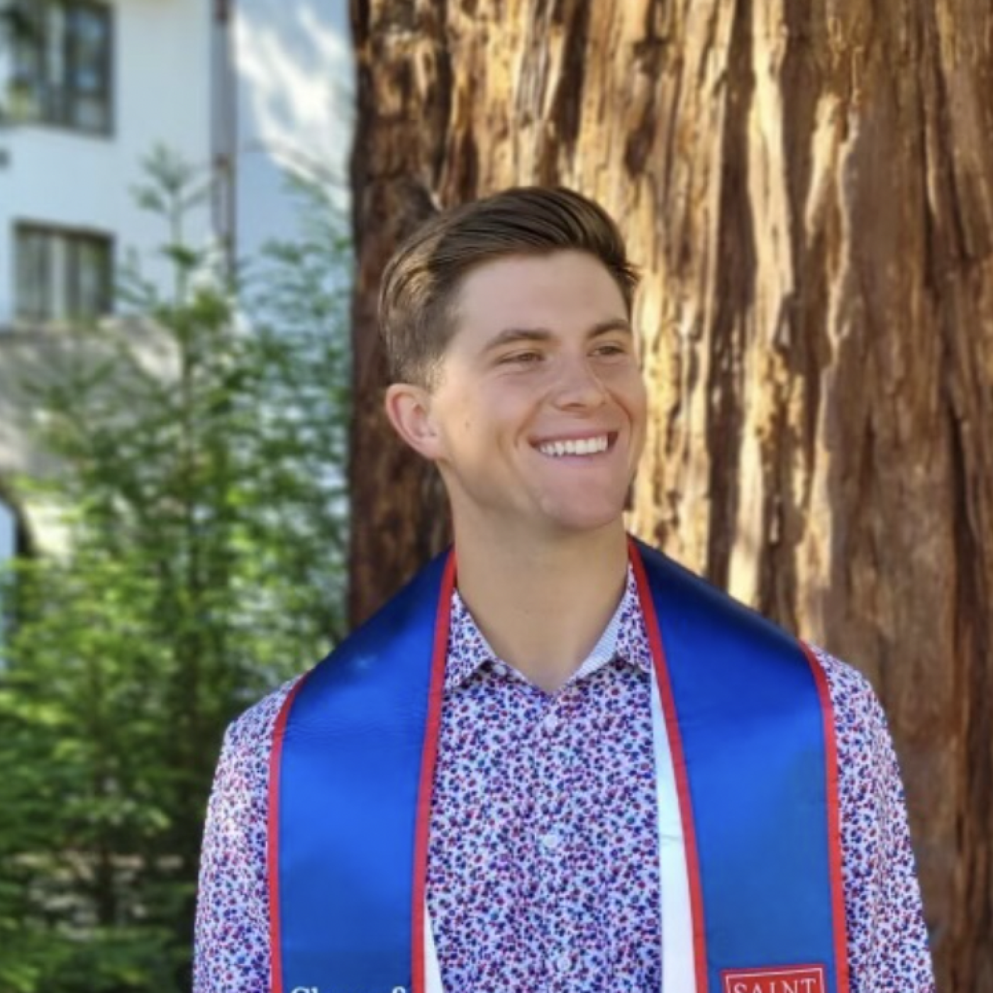 A student posing with a stole around his neck