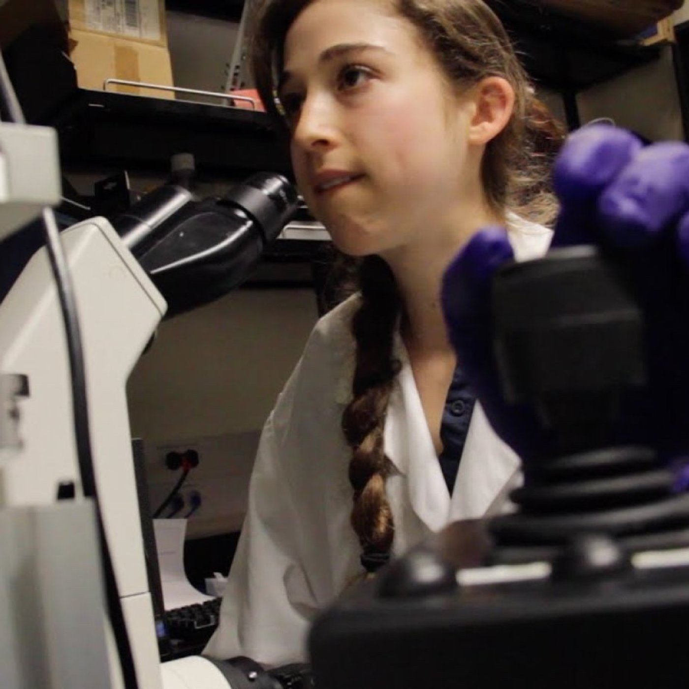 Brianna Bibel '16 at a microscope - for story published March 26, 2023