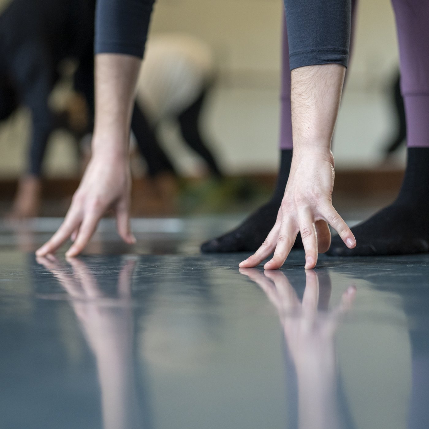 A dancer's fingers touching the floor.